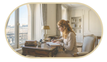 Woman sitting at desk writing in her journal
